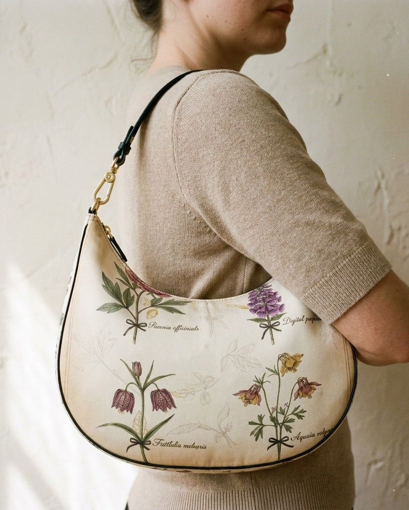 Le Demi-Lune in Herbier Royal — hero flatlay on ivory — botanical print silk twill handbag — Hoboken atelier